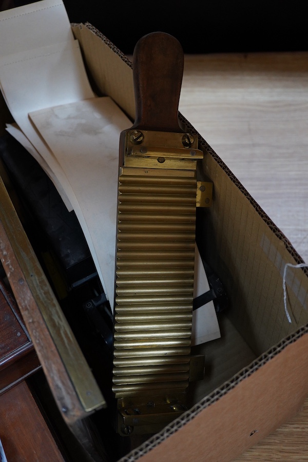 Seven scientific instruments, comprising; a Bimetallic Thermograph Mk III, by Hezzanith; a Victorian mahogany and brass pill roller, reversible, with 24 or 30 grooves; a set of late 19th brass beam scales, the mahogany b